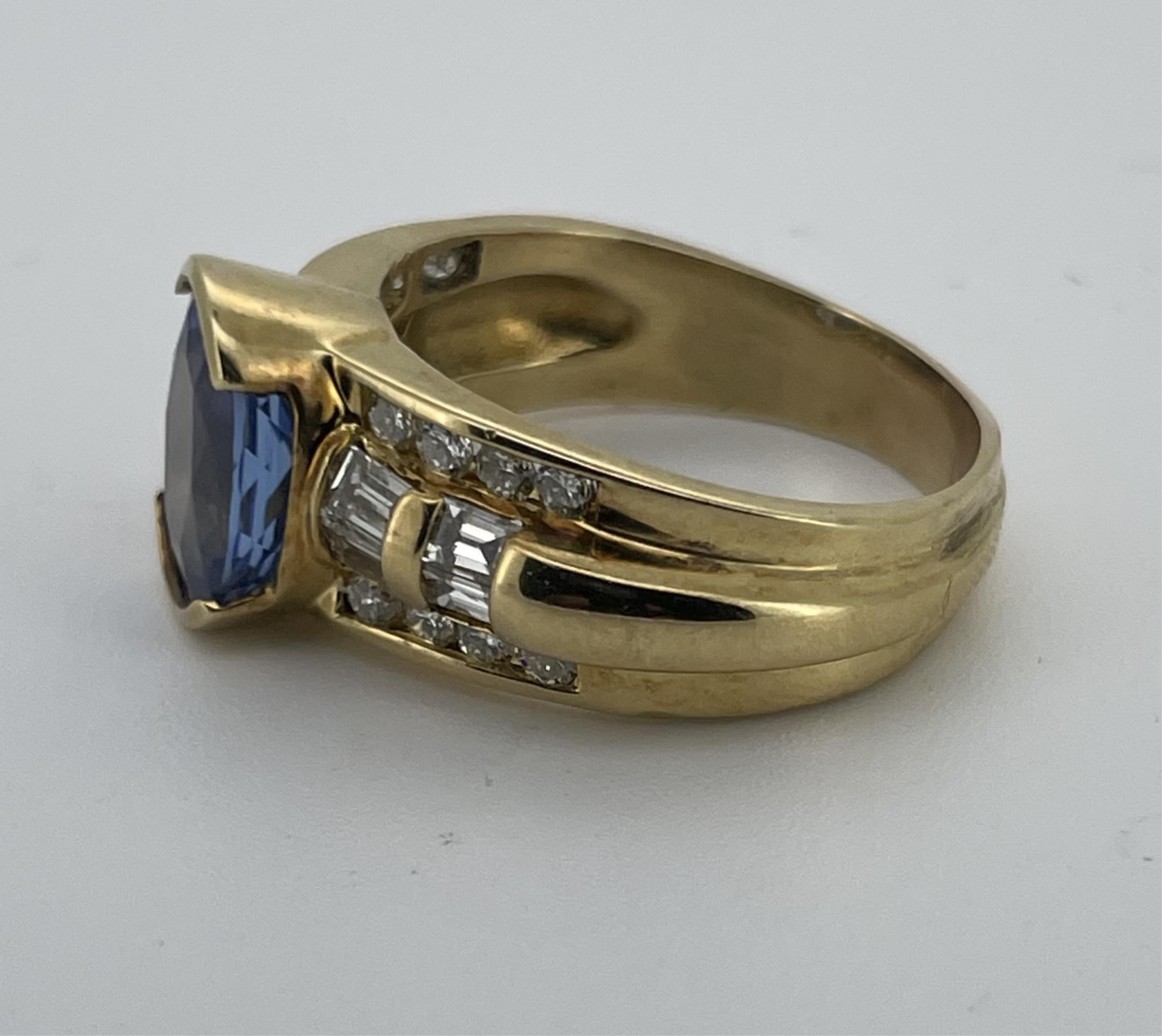 A tanzanite and diamond ring, set with an oval tanzanite measuring approximately 10.9 x 8.3 x 5.5mm, weighing approximately 3.00 carats, to a bombé band set with brilliant-cut and baguette diamonds totalling approximatel